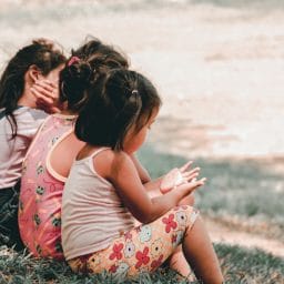 Children sitting on grass