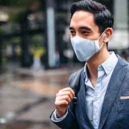 Business man wearing face mask outside.