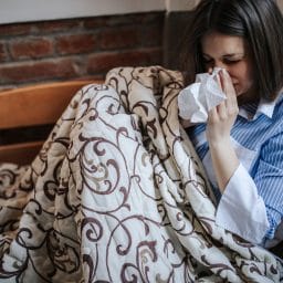 Woman in bed with a cold.
