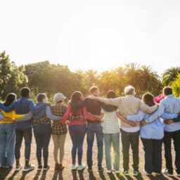 Group of people locking arms, supporting each other